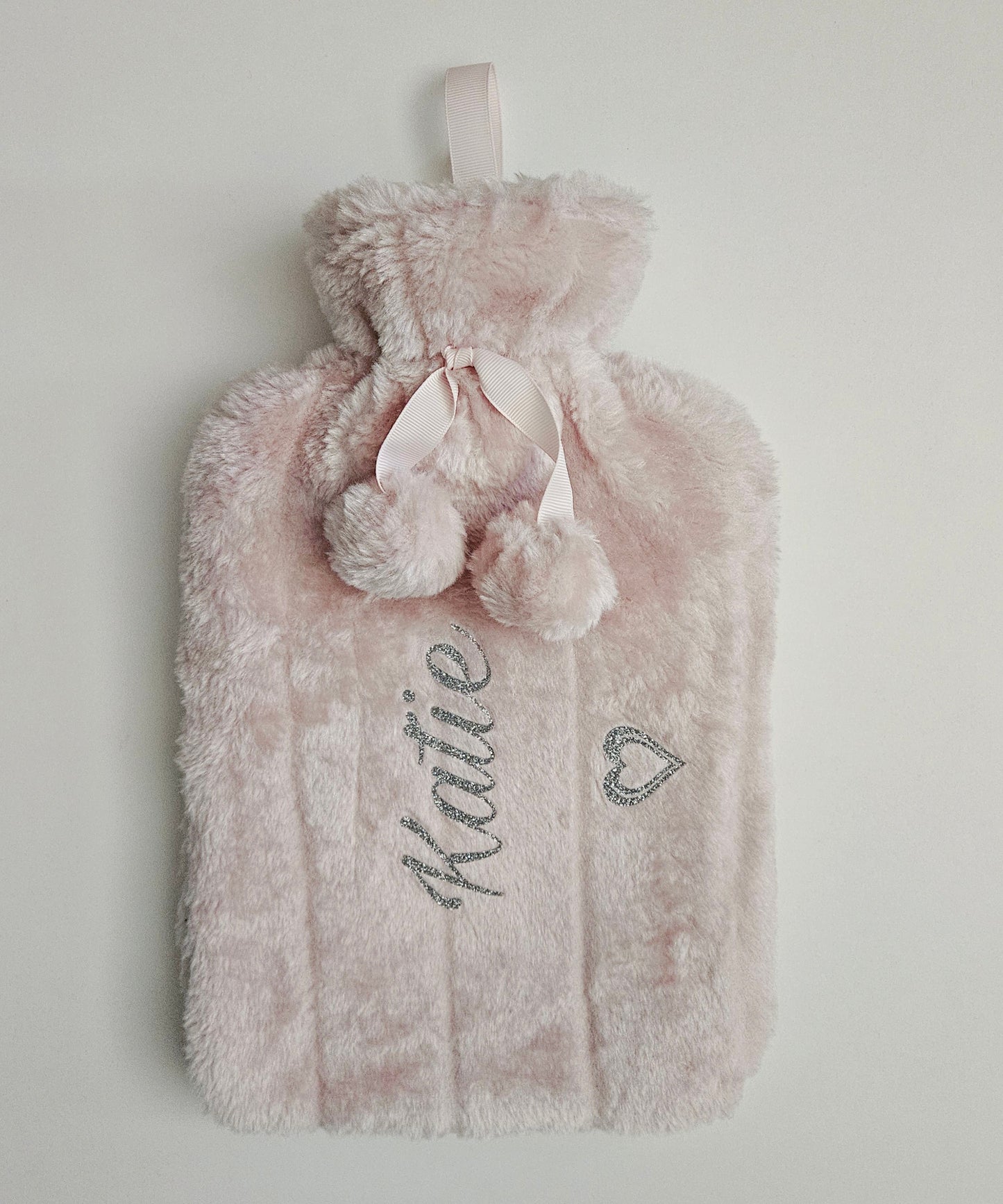 Stay cosy with our custom- made personalised hot water bottles, featuring removable luxurious powder pink faux fur covers. Perfect for gifting, these bespoke hot water bottles add a personal touch to warmth and comfort.