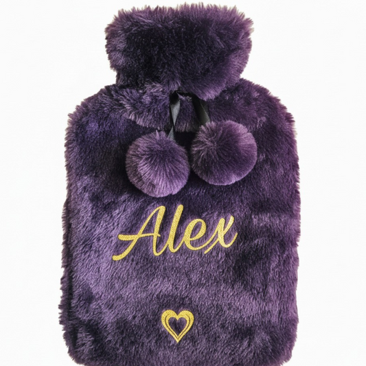 Purple fluffy faux fur hot water bottle with 'Alex' & heart feature in a gold glitter vinyl on a white background
