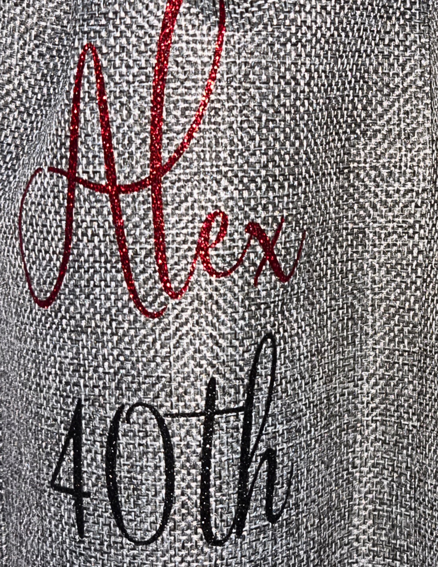 Personalised burlap bottle gift bags with the name 'Alex' in red glitter vinyl & age '40th' in a black glitter vinyl on a grey fabric gift bag.