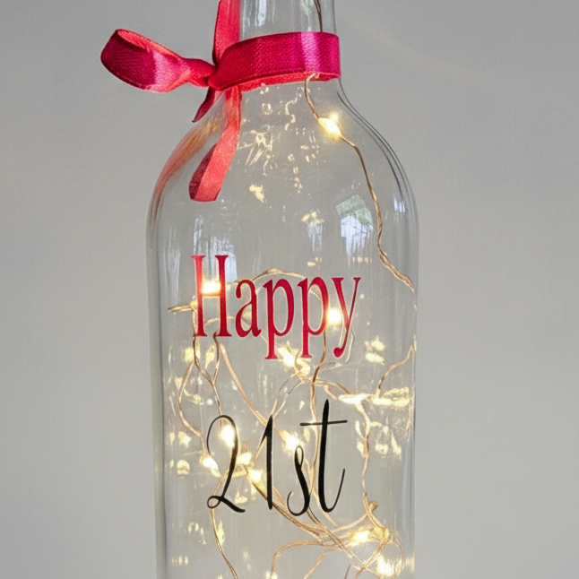 A bottle with lights with 'Happy 21st'