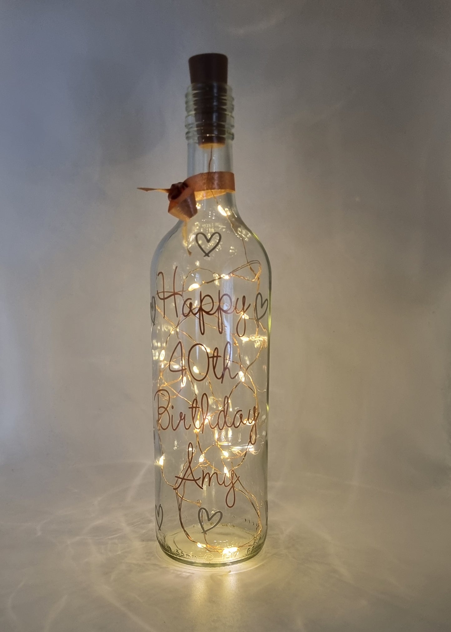 This elegant and best-selling Personalised Light Up Bottle is beautifully decorated with stunning rose gold and glossy silver vinyl accents. This very attractive LED bottle can be personalised with a message of your choice.