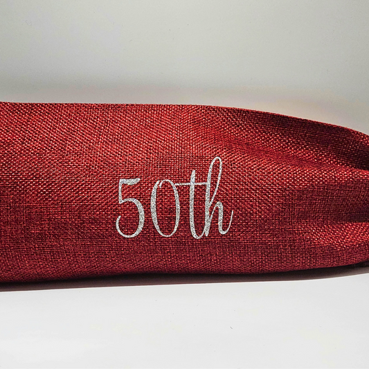 Red burlap bag with '50th' in silver glitter vinyl on a light background