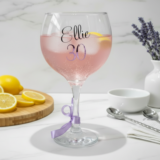 Personalized wine glass with 'Ellie 30' on a table with lemons and lavender.