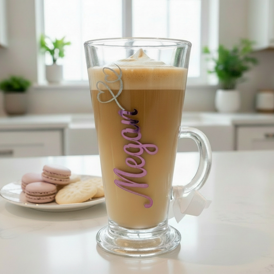 Glass mug with layered drink and 'Megan' decoration on a kitchen counter