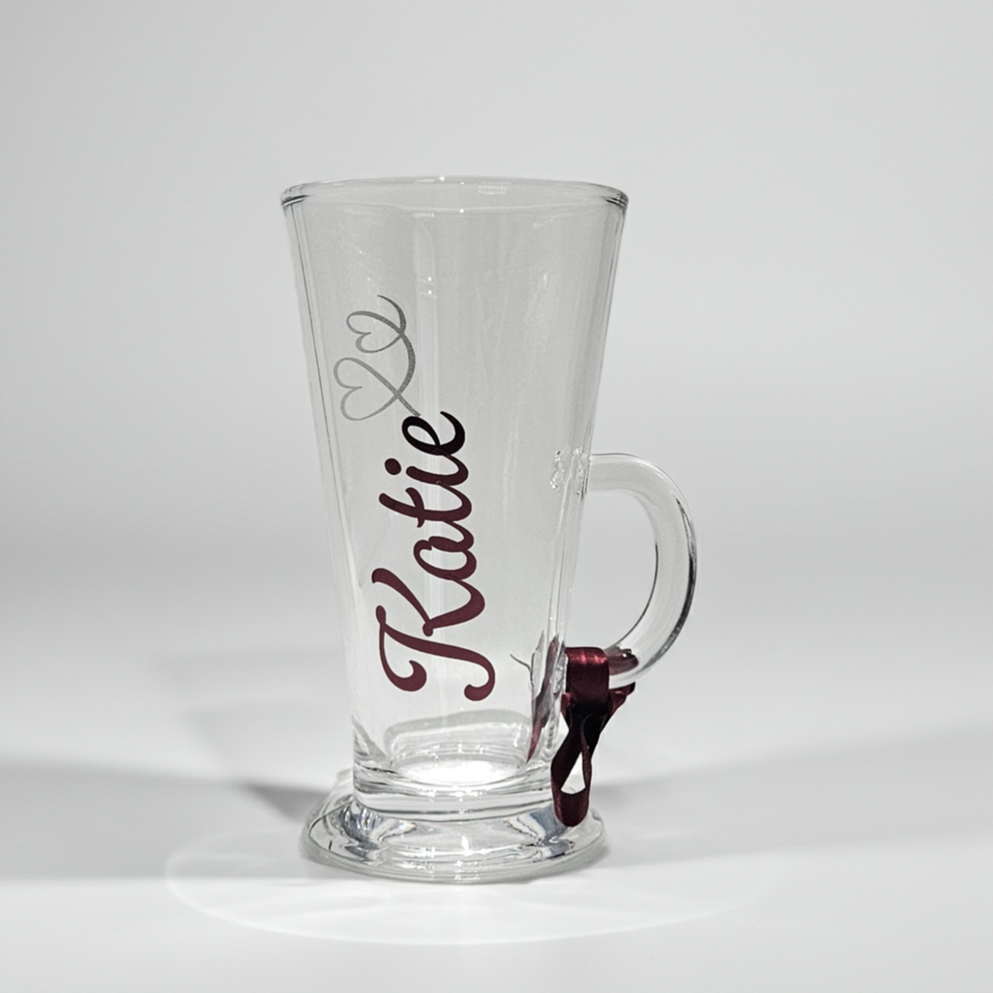 Personalised clear latte coffee glass mug with the name 'Katie' on it on a white background