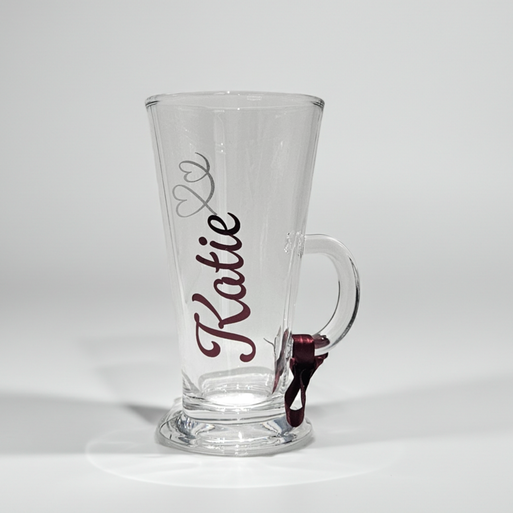 Personalised clear latte coffee glass mug with the name 'Katie' on it on a white background